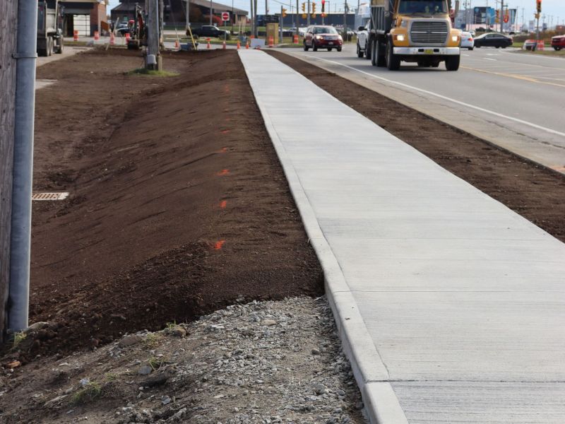Landscaping work as the sidewalk project on Starrs Road is completed.